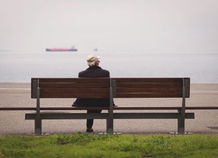 Man sitting on a bench at the beach