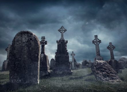 Spooky old graveyard at night
